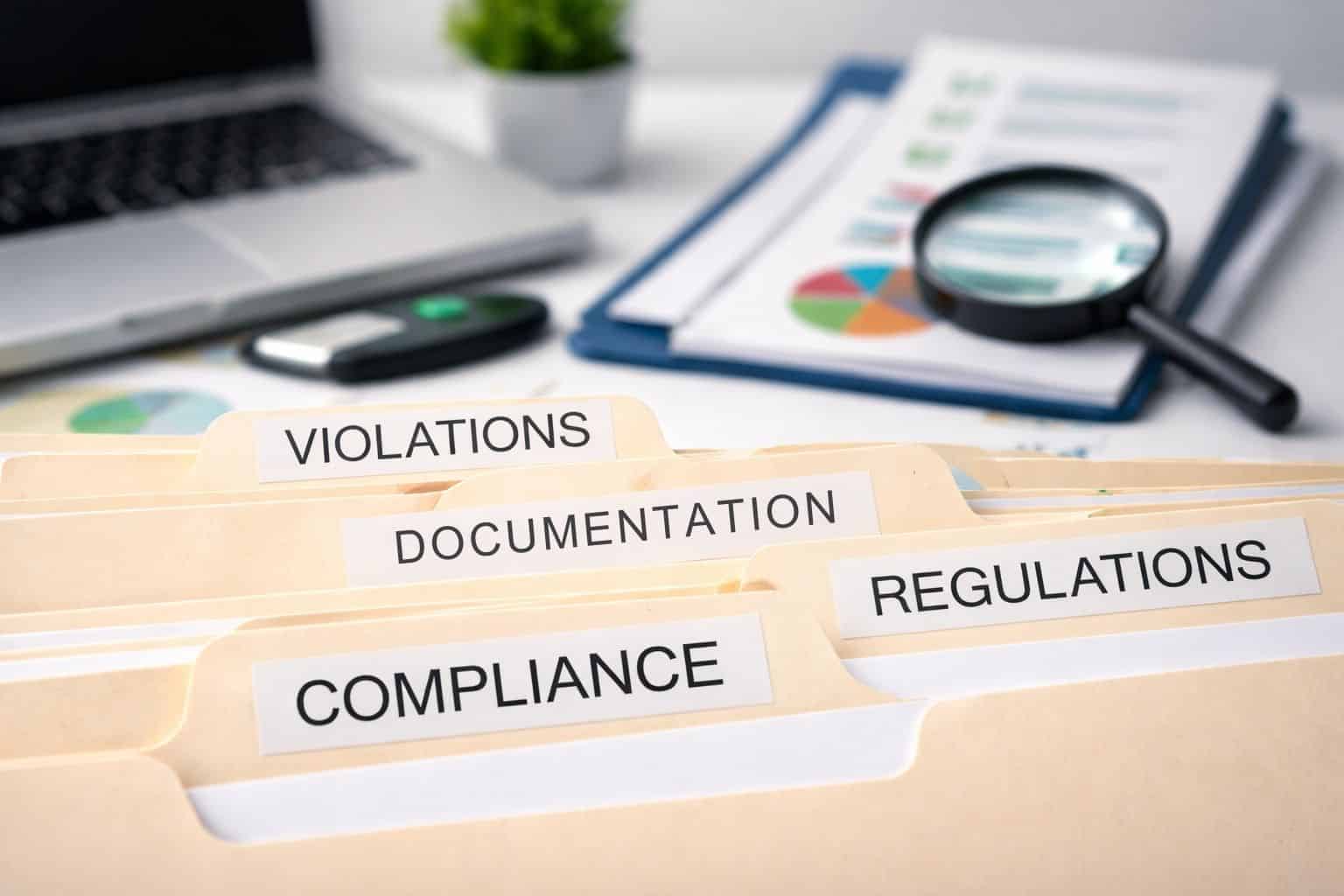 documentation compliance regulations violations words on a table