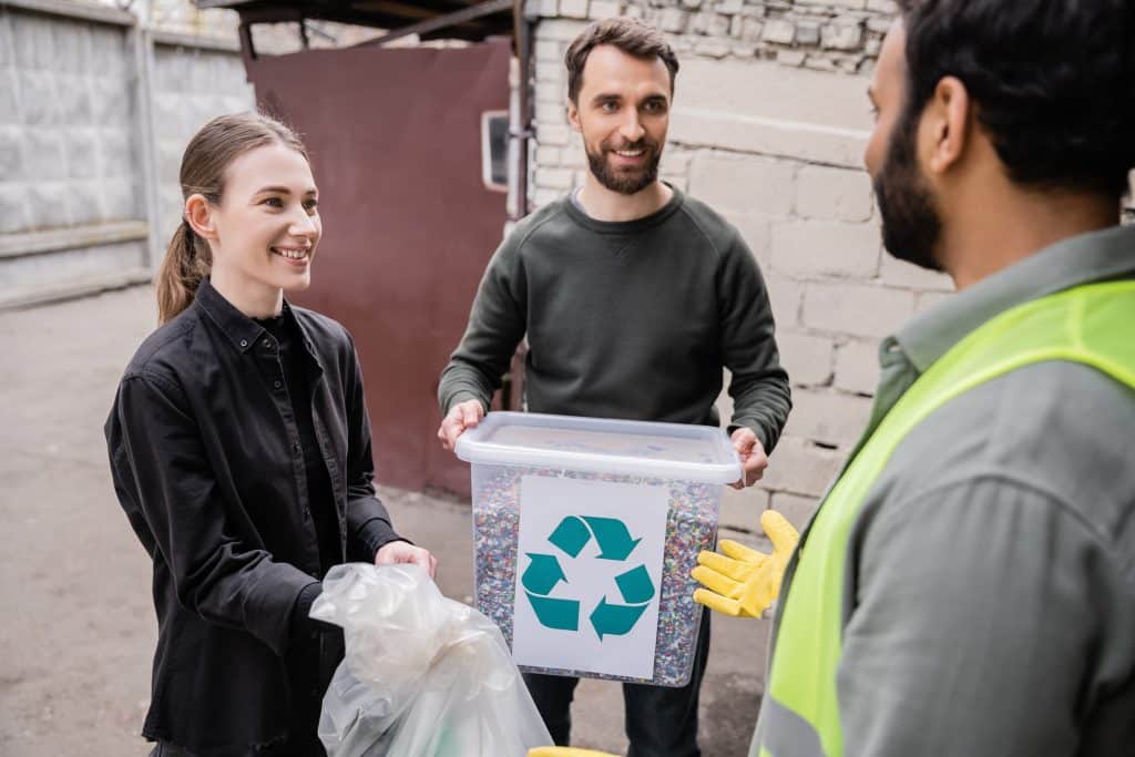 Staff Recycling Together Outdoors