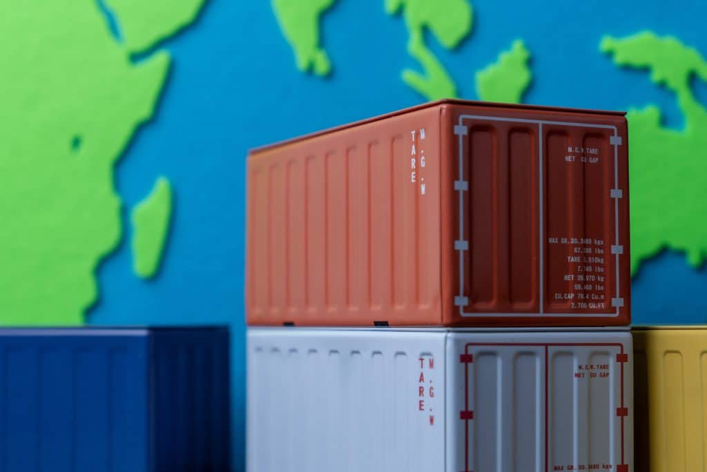 Shipping Containers Stacked in Front of World Map for DIWASS
