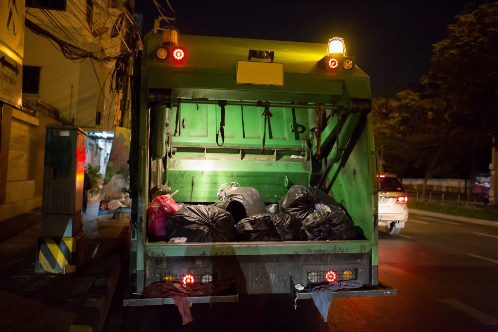 Garbage Truck Full of Trash in Urban Setting