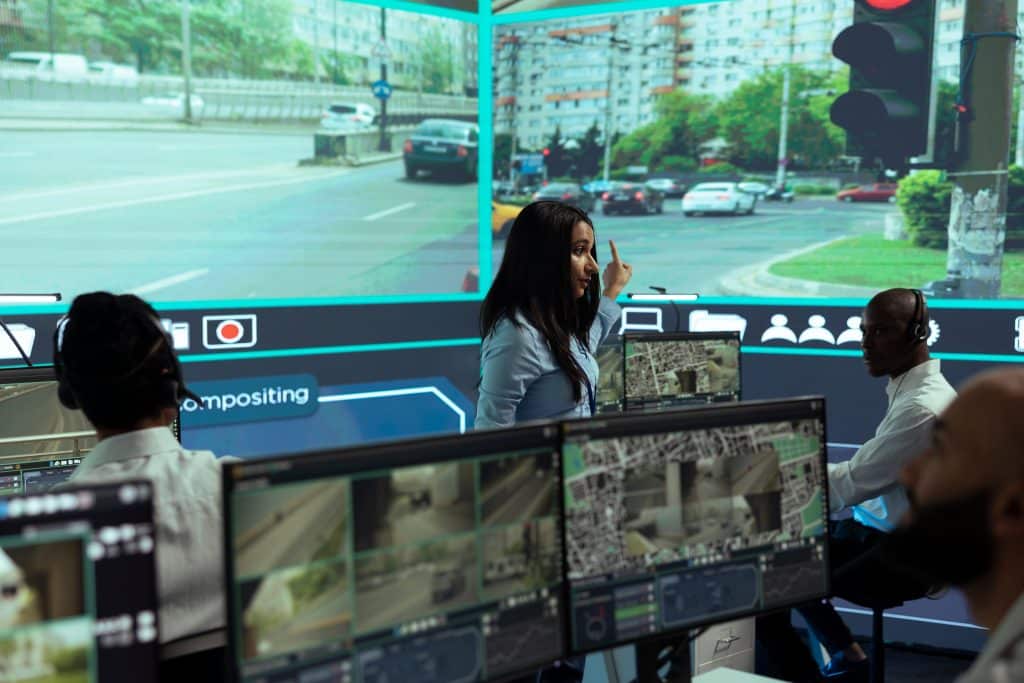 Woman Explains AI camera system for waste management Data To Colleagues In Office