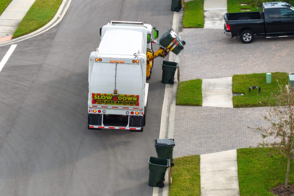 Garbage Truck Collecting Bins in a Suburban Neighborhood