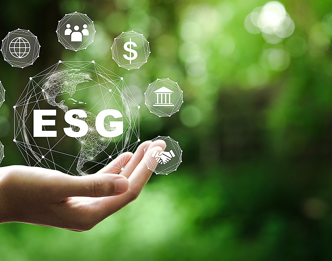 A hand holding a glowing globe surrounded by ESG icons, representing environmental, social and governance reporting