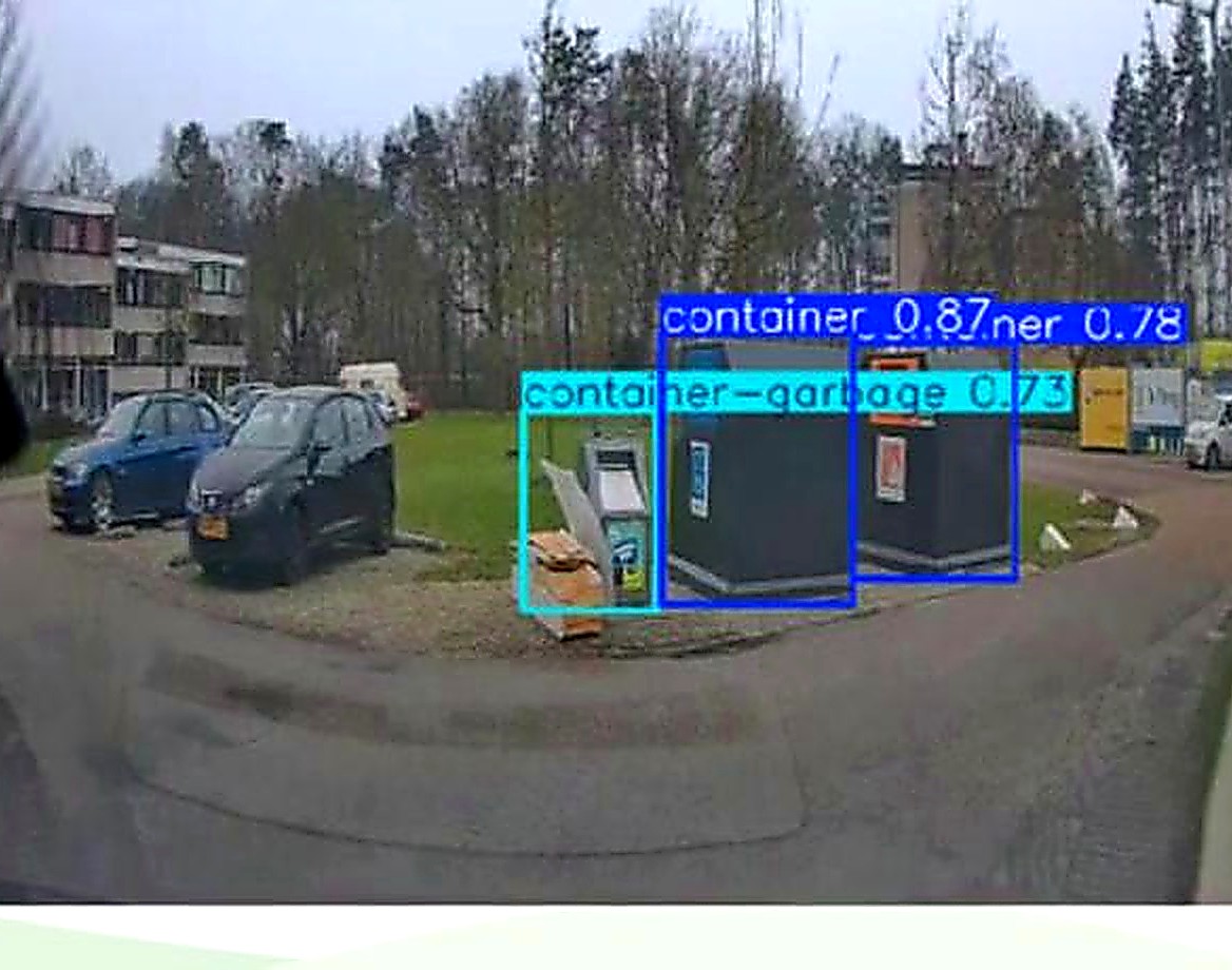 Evreka AI Camera live detection view showing bounding boxes and confidence scores around a container and fly-tipped waste beside it