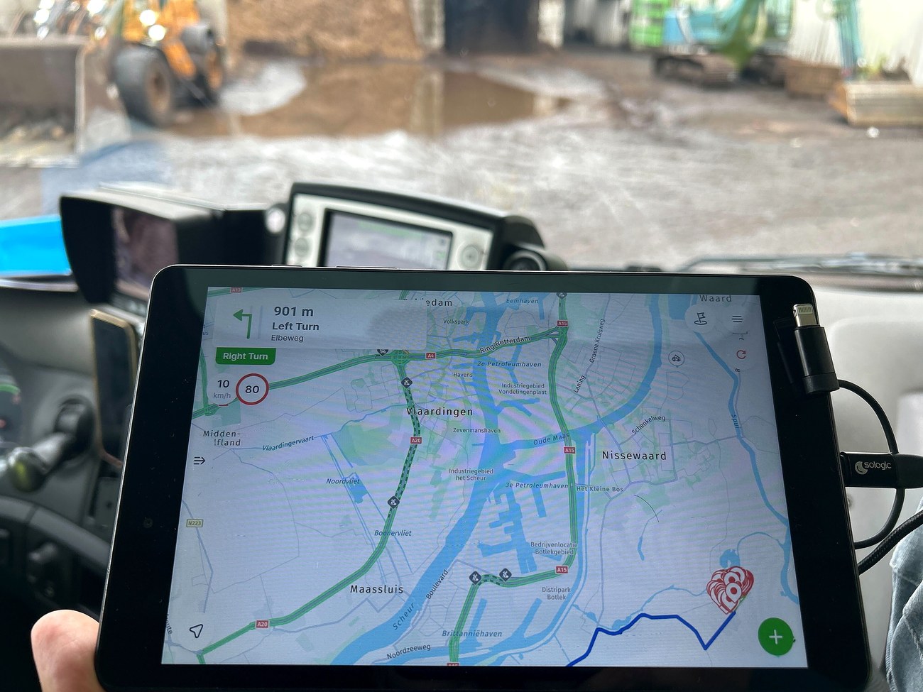In-cab tablet showing turn-by-turn navigation on a commercial collection route