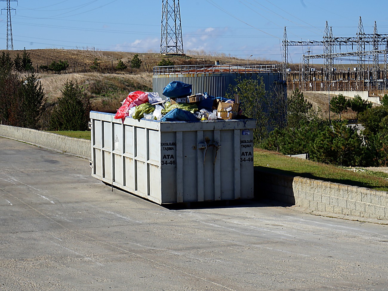 A waste container overflowing with bags and boxes, an example of the kind of overflow Evreka AI Camera flags automatically